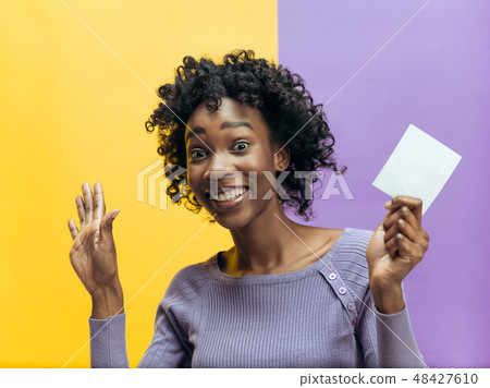 Young woman with a surprised expression won a bet 48427610