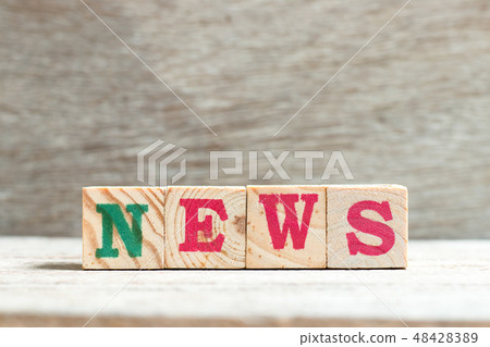 Letter block in word news on wood background 48428389