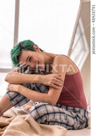 Slim woman chilling in her bed while having day off Slim woman chilling in her bed while having day off 48428791