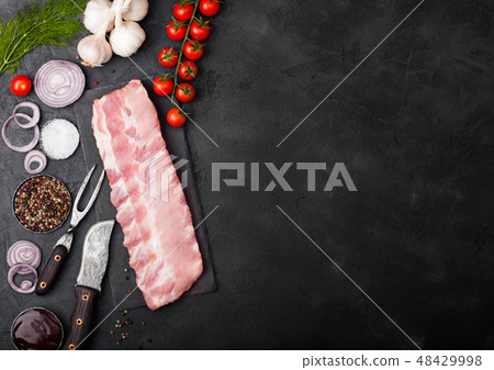 Fresh raw pork ribs on chopping board Fresh raw pork ribs on chopping board 48429998