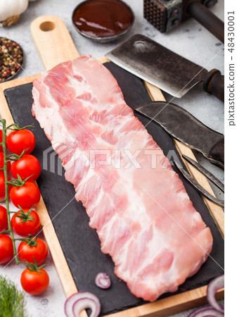 Fresh raw pork ribs on chopping board Fresh raw pork ribs on chopping board 48430001
