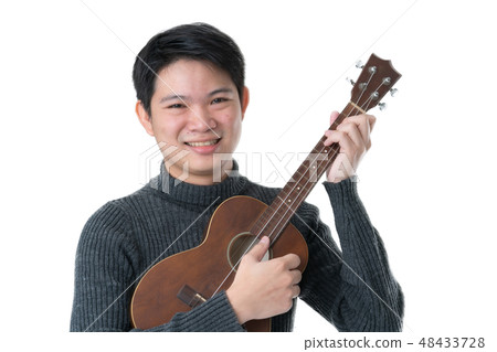 friendly asian man enjoy play sing with ukulele friendly asian man enjoy play sing with ukulele 48433728