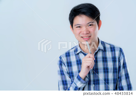 casual relax asian smart man thinking with pen  48433814