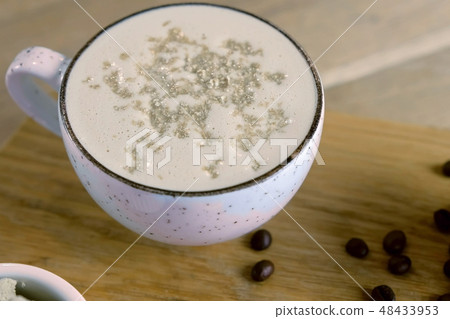 Cup of coffee with halva served on a tray with honey and coffee beans. 48433953