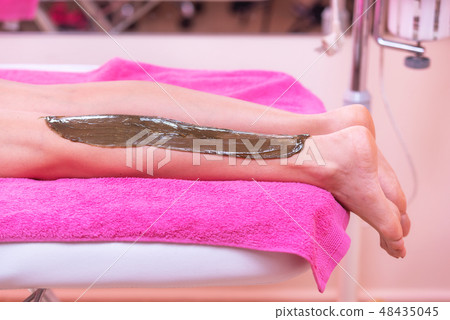 Beautician waxing woman legs, depilation in beauty Spa. Beautician waxing woman legs, depilation in beauty Spa. 48435045