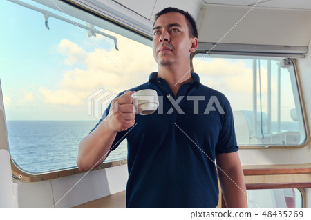 Portrait of navigator pilot officer on the bridge of the vessel Portrait of navigator pilot officer on the bridge of the vessel 48435269