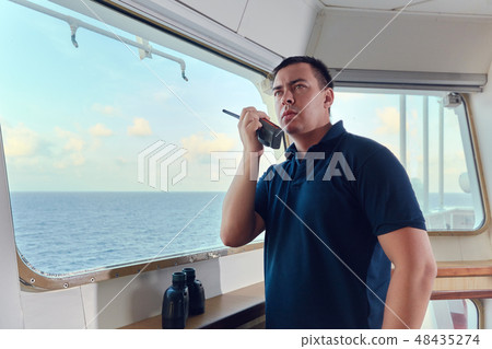 Portrait of navigator pilot officer on the bridge of the vessel 48435274