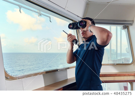 Portrait of navigator pilot officer on the bridge of the vessel 48435275