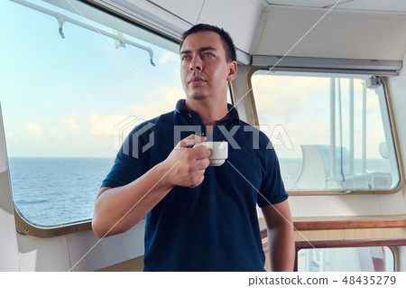 Portrait of navigator pilot officer on the bridge of the vessel Portrait of navigator pilot officer on the bridge of the vessel 48435279