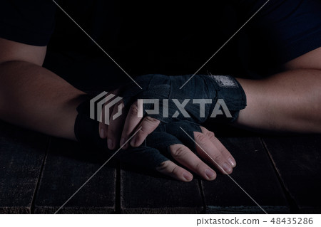 Hands of fighter in modern style on black background. Health care concept. 48435286