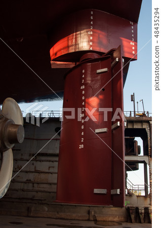 View of ship propeller and rudder in a dry dock  48435294