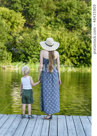 Beautiful mother with her little son are standing 48435909