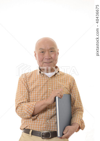 A smiling senior who reads a book A smiling senior who reads a book 48436675
