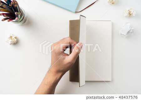 man hand hold brown notebook on white background 48437576