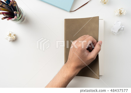 man hand hold brown notebook on white background 48437577