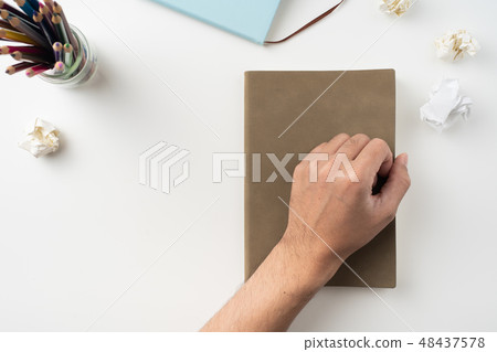 man hand hold brown notebook on white background man hand hold brown notebook on white background 48437578