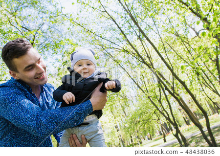 Happy young family spending time together outside Happy young family spending time together outside 48438036
