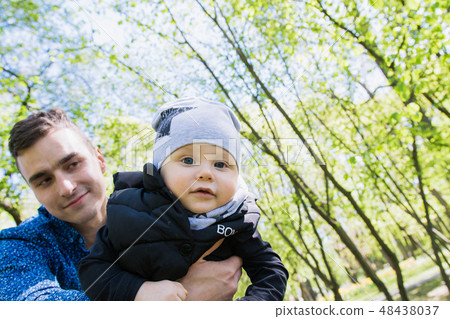 Happy young family spending time together outside 48438037