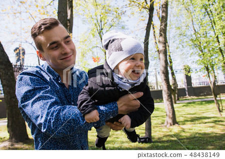 Happy young family spending time together outside Happy young family spending time together outside 48438149