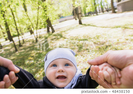 Happy young family spending time together outside 48438150