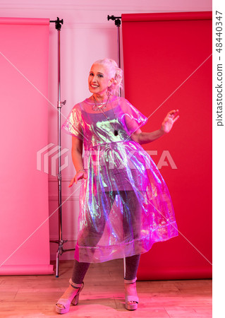 Positive delighted mature female dancing during shooting 48440347