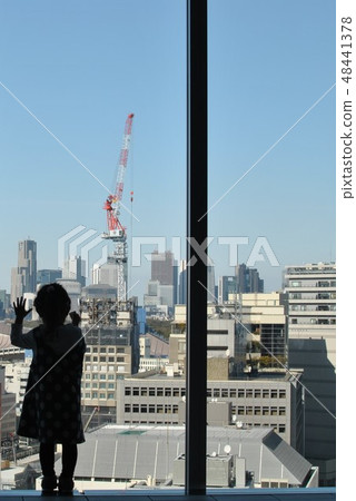 A girl looking at the Shinjuku secondary city center in the distance 48441378