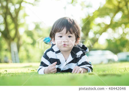Closeup asian kid lied in the garden  48442046