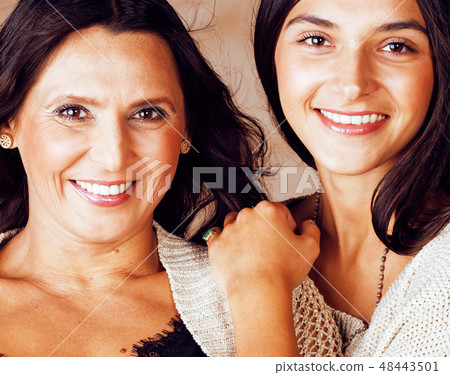 cute pretty teen daughter with mature mother hugging, fashion stylish brunette closeup cute pretty teen daughter with mature mother hugging, fashion stylish brunette closeup 48443501