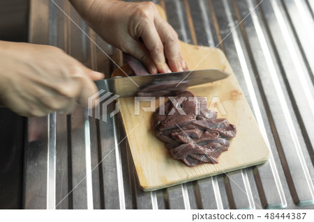 Chef cutting meat. Chef cutting meat. 48444387