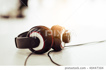 headphone on the white table with light flare headphone on the white table with light flare 48447384