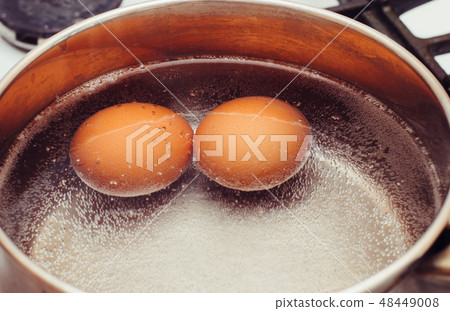 Eggs are cooked on the gas stove 48449008