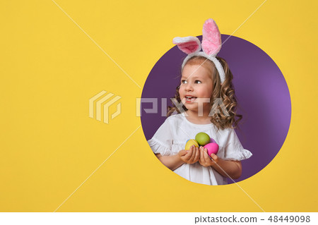 Girl with painted eggs 48449098