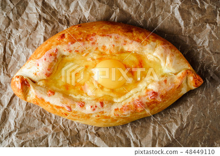 khachapuri on parchment for baking with egg inside khachapuri on parchment for baking with egg inside 48449110