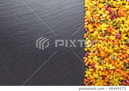 multicolored pasta on a black background multicolored pasta on a black background 48449173