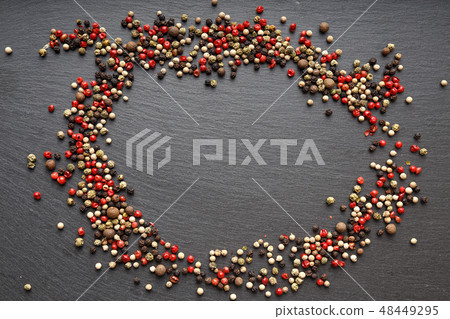 pepper scattered on slate, top view 48449295
