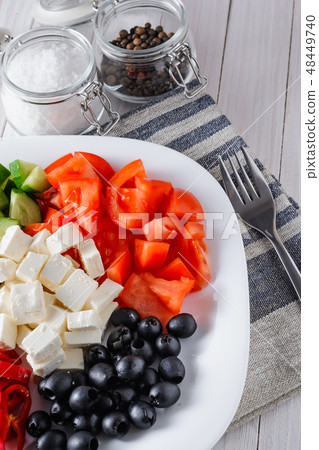 salad of tomatoe, olives, cucumber and feta cheese 48449740