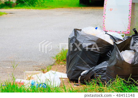 Pile black garbage bag roadside in the city Pile black garbage bag roadside in the city 48451148