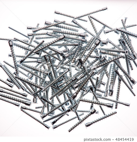 Mound of furniture screws top view on white Mound of furniture screws top view on white 48454419