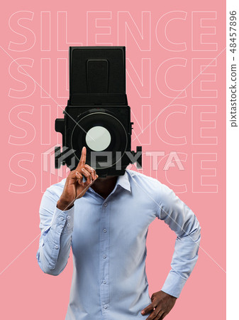 Studio portrait of young man covering his mouth - speak no evil concept Studio portrait of young man covering his mouth - speak no evil concept 48457896