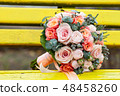 Bride and groom in bright clothes on the bench 48458260