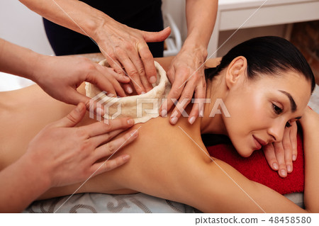 Masters molding clay figure on back of their client Masters molding clay figure on back of their client 48458580