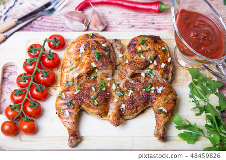 Fried chicken tobacco (tabaka) on the board. Fried chicken tobacco (tabaka) on the board. 48459826