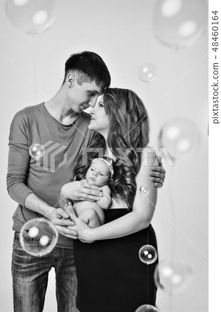 baby on the hands of parents on a white background baby on the hands of parents on a white background 48460164
