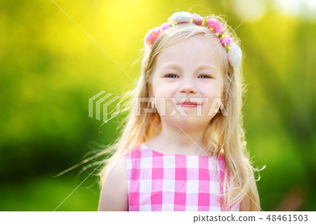 Portrait of cute little girl outdoors on warm and sunny summer day 48461503