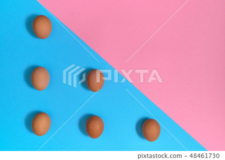 Chicken eggs on blue and pink pastel background Chicken eggs on blue and pink pastel background 48461730