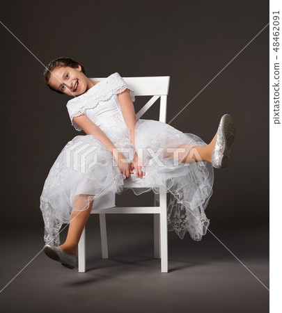 little girl dressed in a white ball gown little girl dressed in a white ball gown 48462091