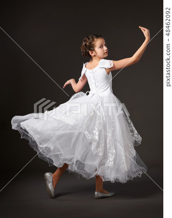 little girl dressed in a white ball gown little girl dressed in a white ball gown 48462092