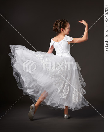 little girl dressed in a white ball gown little girl dressed in a white ball gown 48462093