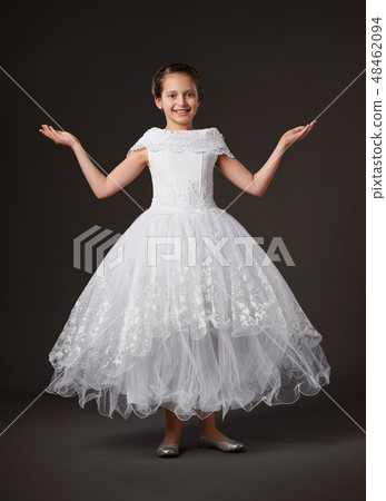 little girl dressed in a white ball gown little girl dressed in a white ball gown 48462094