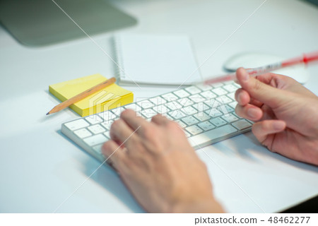 Selective focus on white keyboard of desktop  48462277